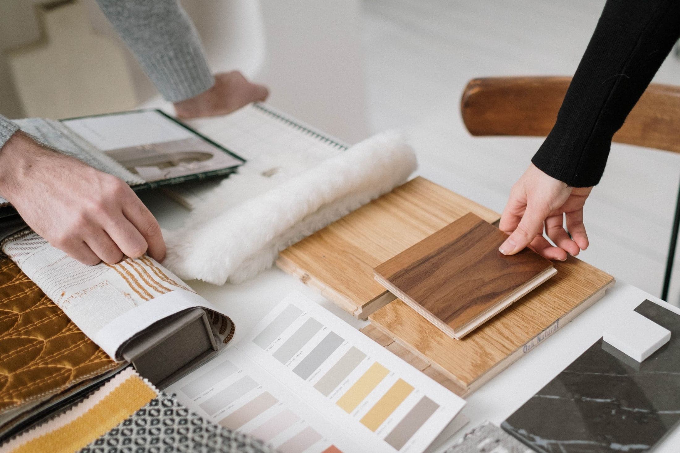 Hands reviewing product samples on a sourcing table